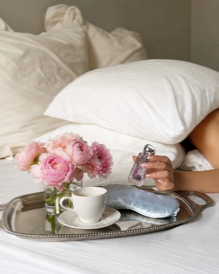 Peace Offering bottle on a breakfast tray in bed with pink roses